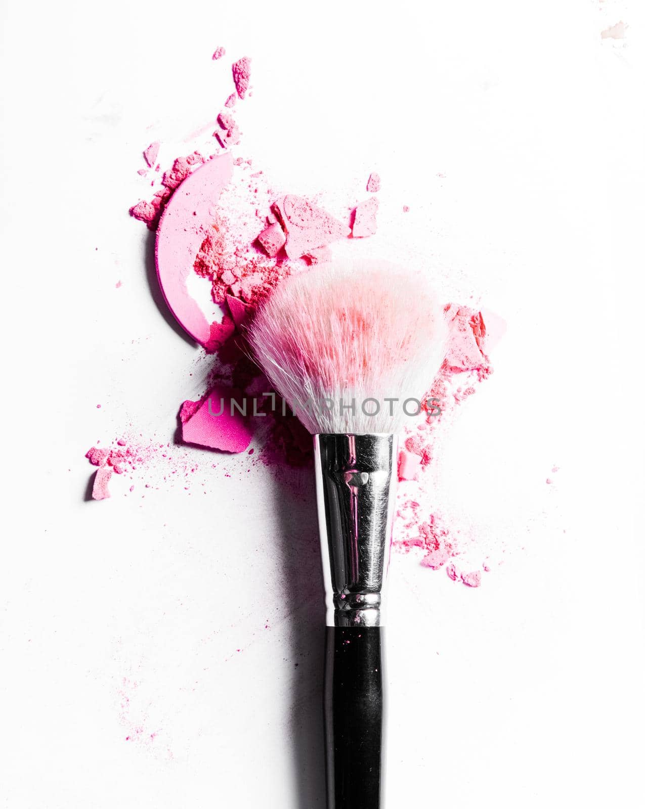 Brush with crushed eyeshadow and powder close-up isolated on white background by Anneleven
