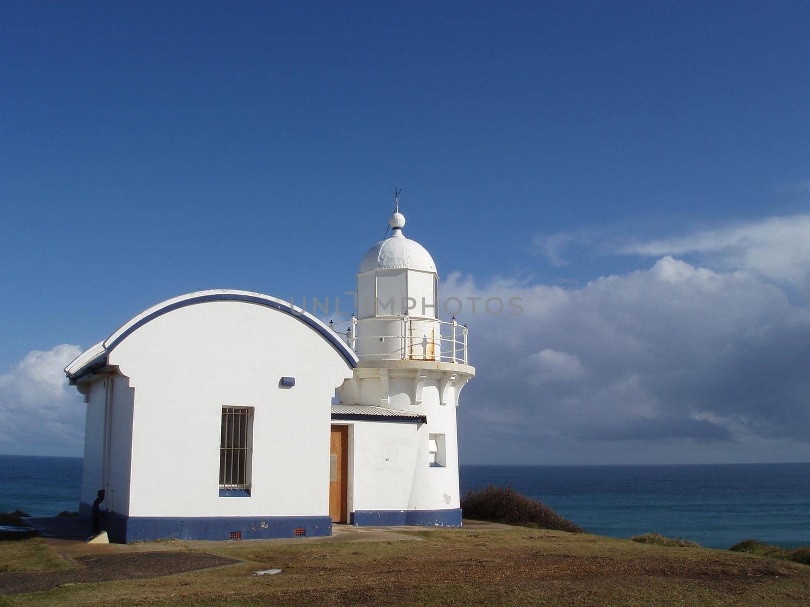 Quaint whitewashed lighthouse on the northern coast of NSW, Australia overlooking the sea to aid shps in navigation or warn of a natural hazard