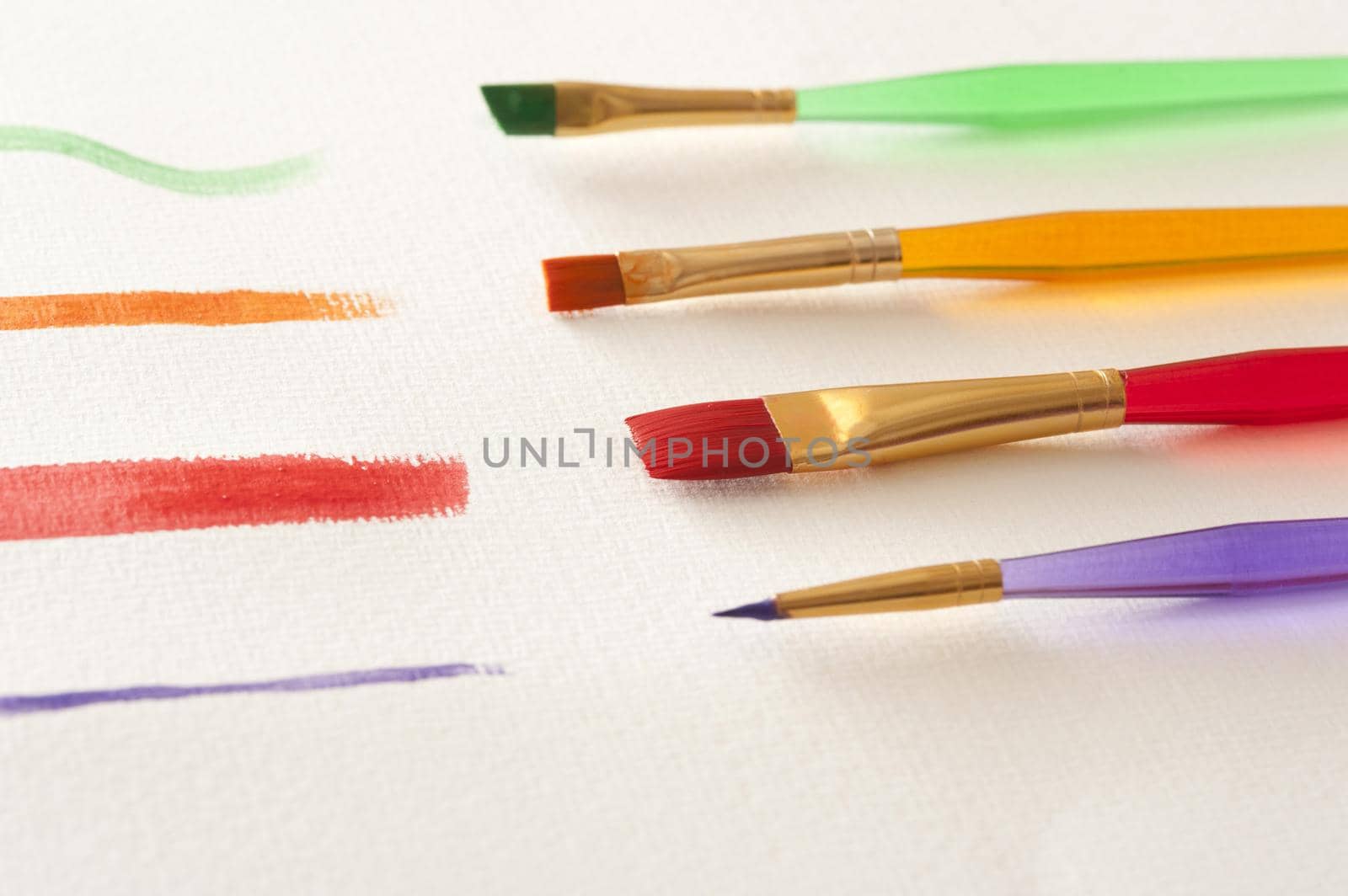 Green, orange, red and purple straight paint strokes with plastic brushes on canvas