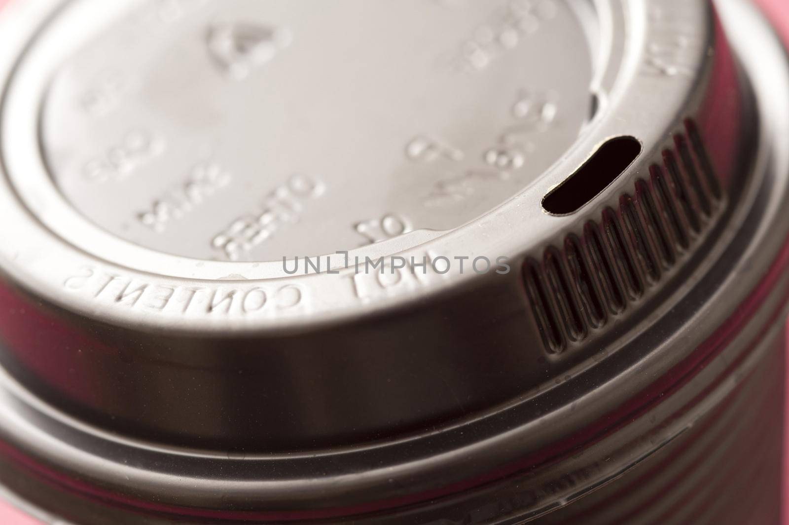 Detail of the lid of a plastic takeaway coffee cup viewed at an angle to enhance the text - hot contents - on the rim