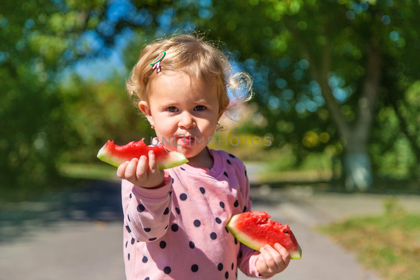 The child eats watermelon in summer. Selective focus. Kid.