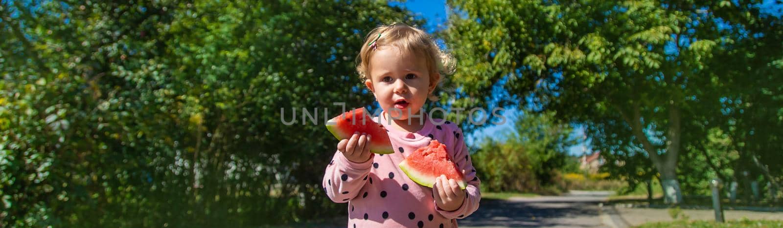 The child eats watermelon in summer. Selective focus. by yanadjana