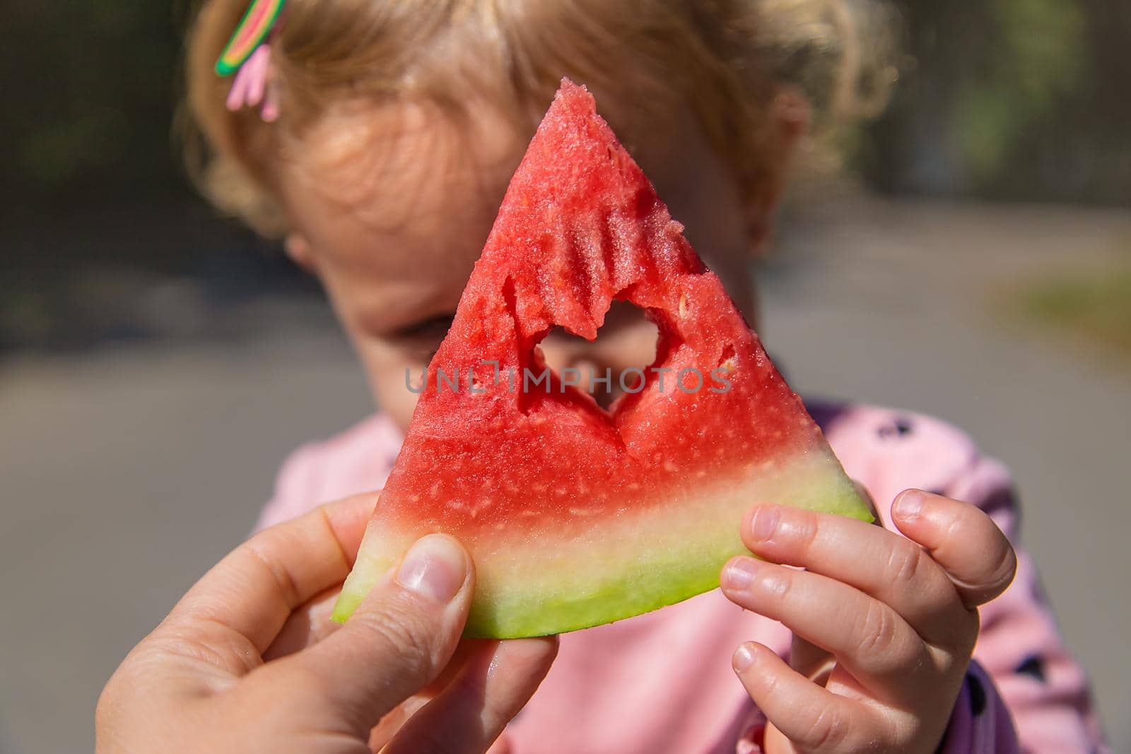 The child eats watermelon in summer. Selective focus. Kid.