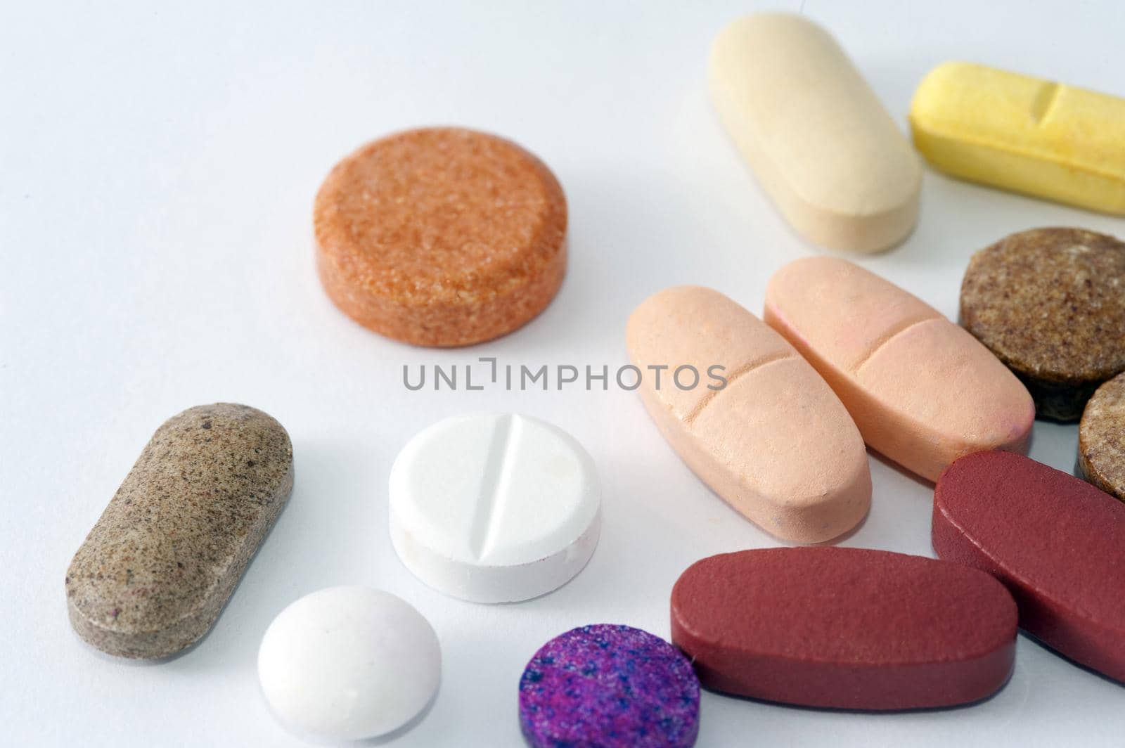 various shaps of pills on a white background