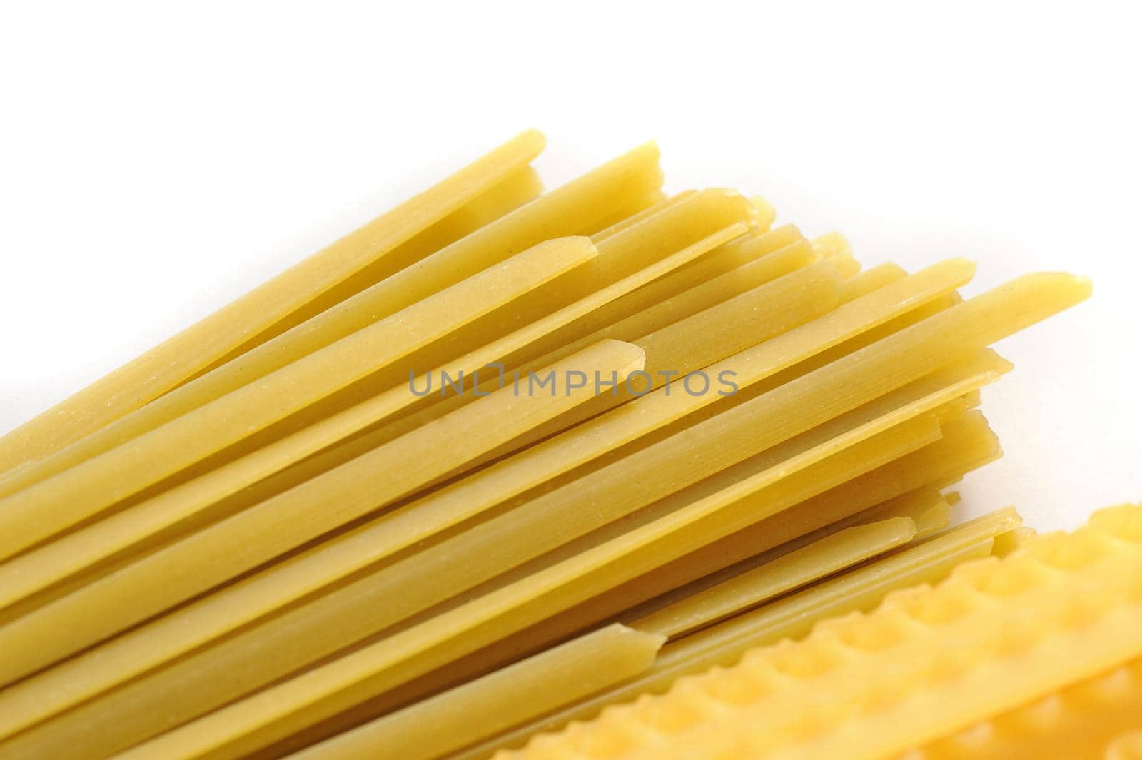 Photo of gold raw noodles on white background. Isolated