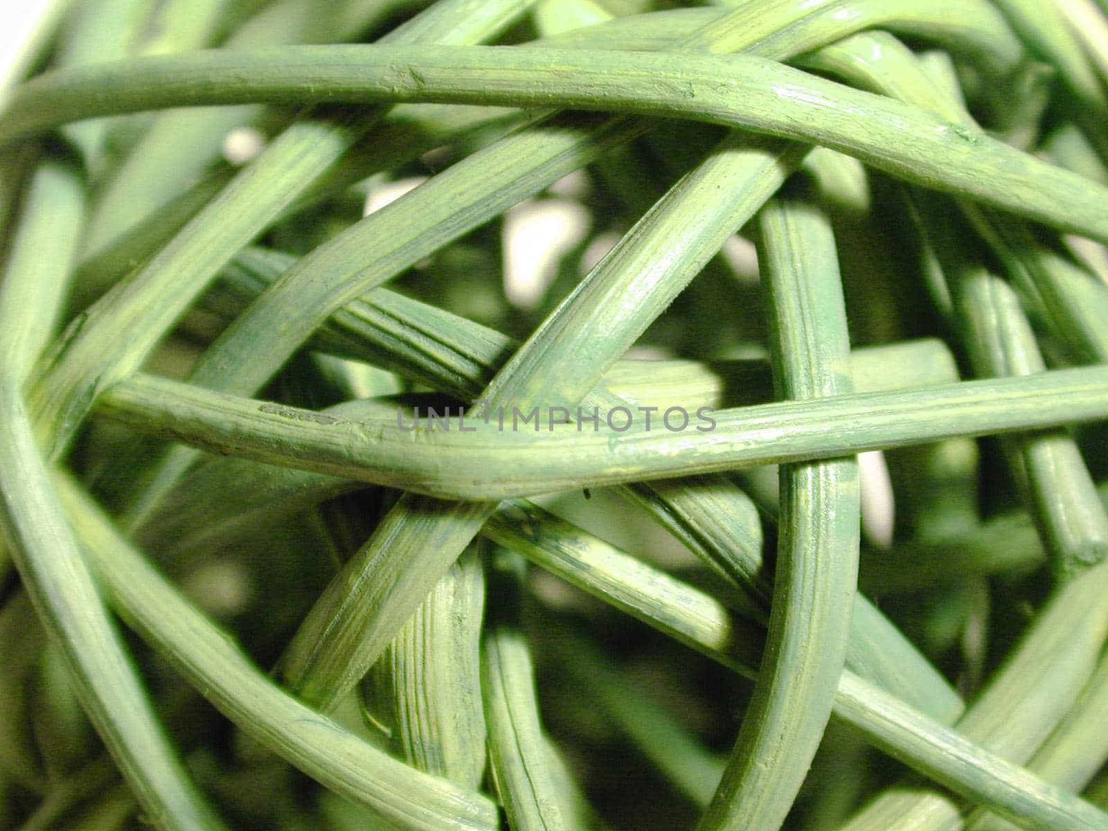 Background texture of random woven green rushes, close up full frame