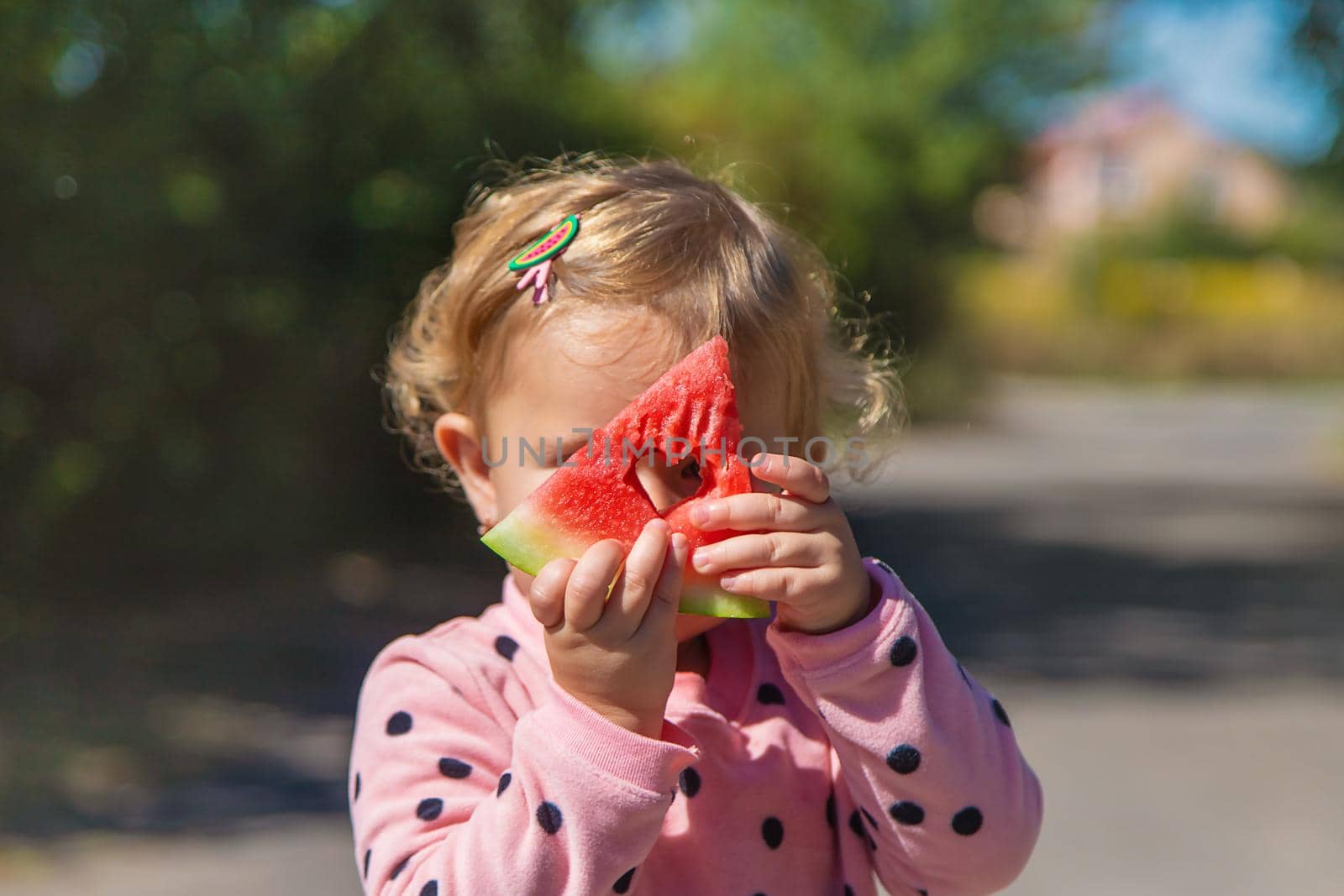 The child eats watermelon in summer. Selective focus. Kid.