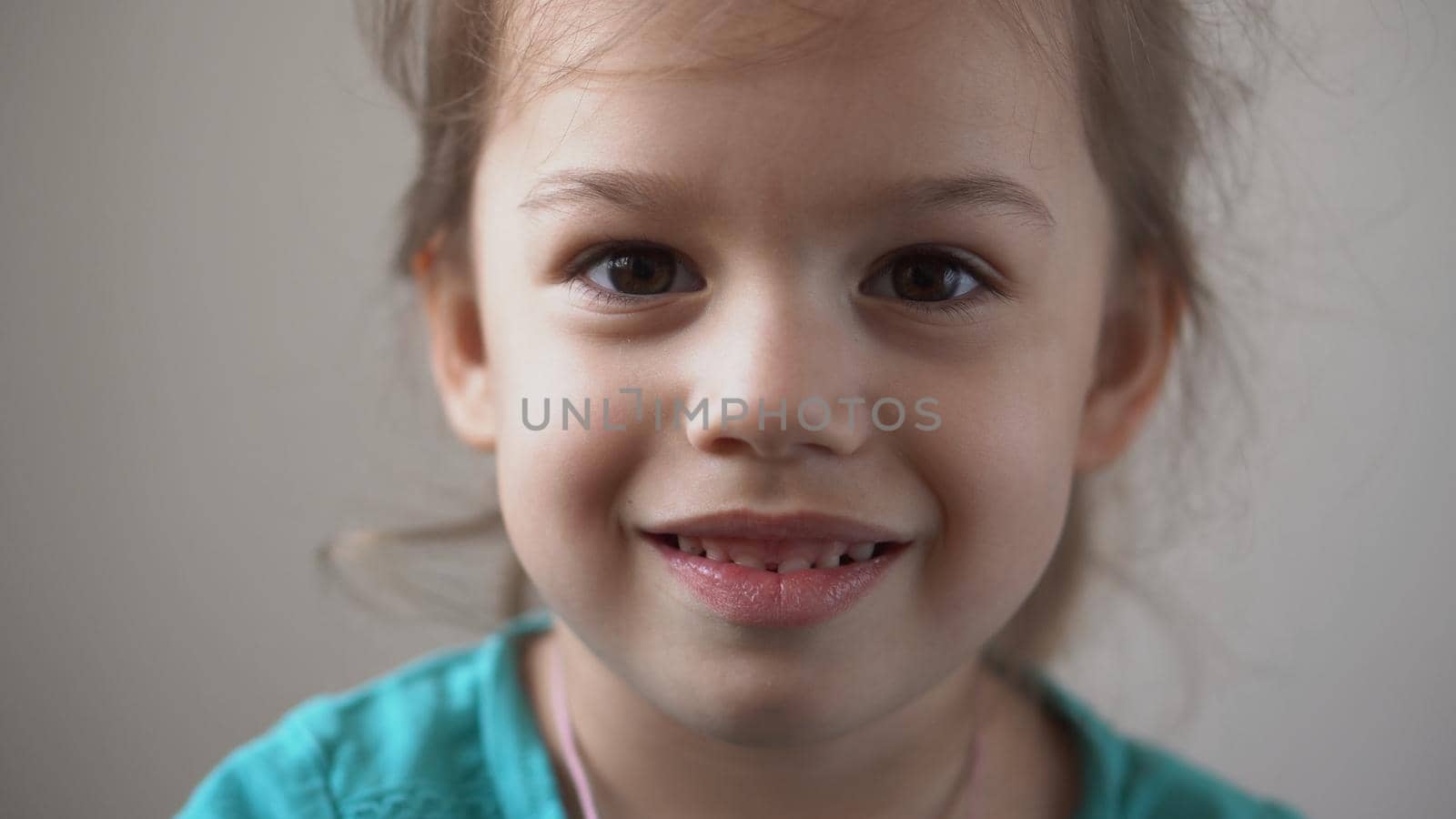 Portrait Funny Happy little kid close up happy preschool girl smiling child looking at camera pretty natural face. sincere emotions ashamed, embarrassed clean skin dermatology, pediatric dentistry by mytrykau