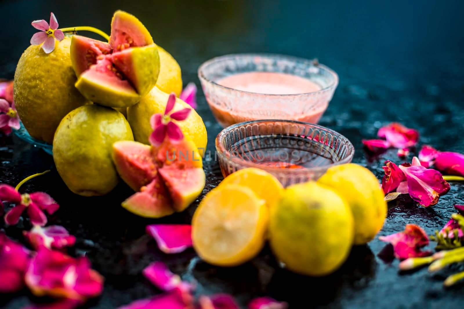 The easiest method to cure acne and scars with guava face mask consisting of guava pulp, honey, and some lemon juice.With ingredients on wooden surface in a glass bowl.;