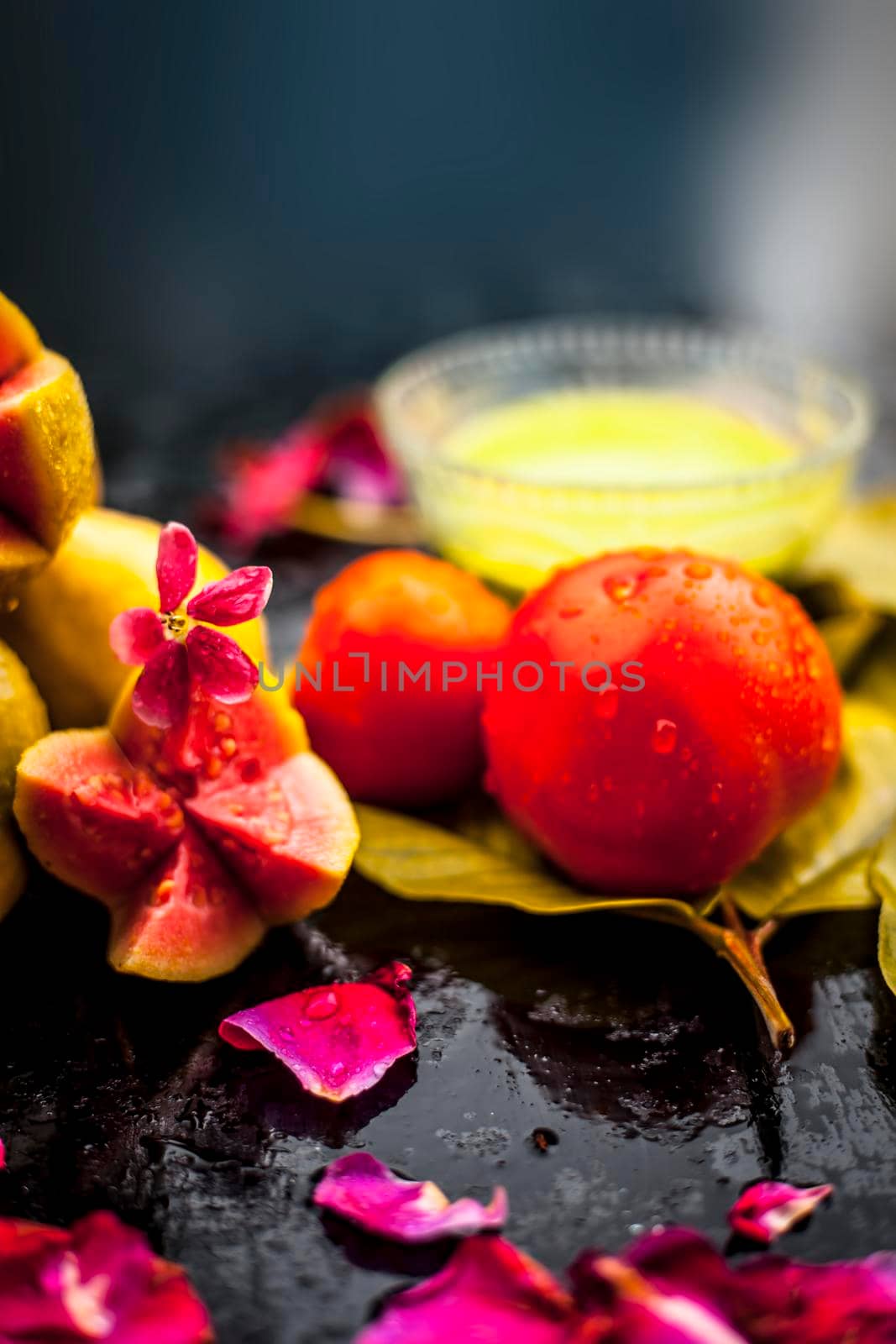 Best cheap face mask for tanned skin on wooden surface un a glass bowl consisting of guava leaves paste well mixed with some tomato pulp. Shot with entire ingredients with fantastic colors.