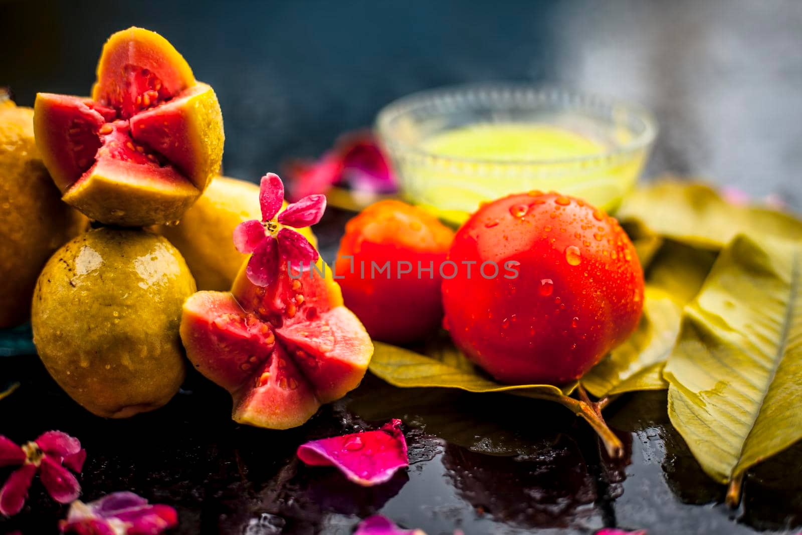 Best cheap face mask for tanned skin on wooden surface un a glass bowl consisting of guava leaves paste well mixed with some tomato pulp. Shot with entire ingredients with fantastic colors. by mirzamlk