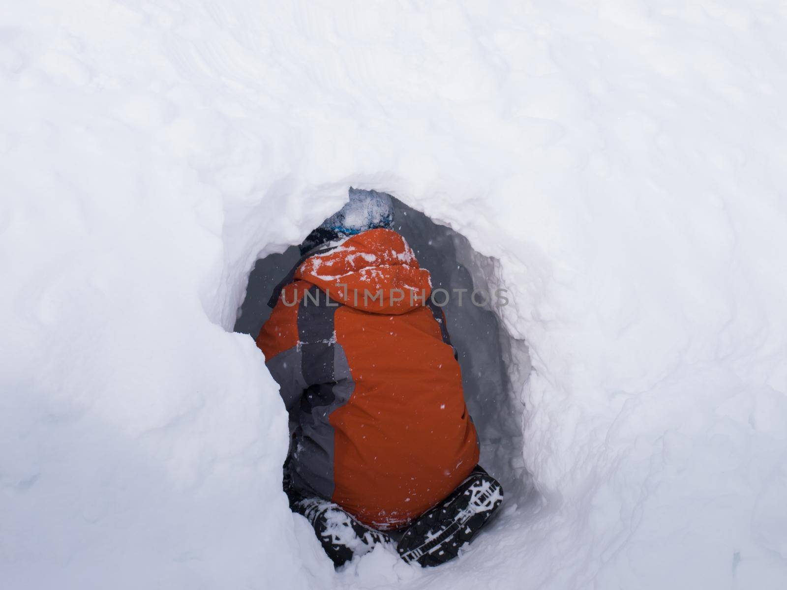 A boy digging the snow cave.