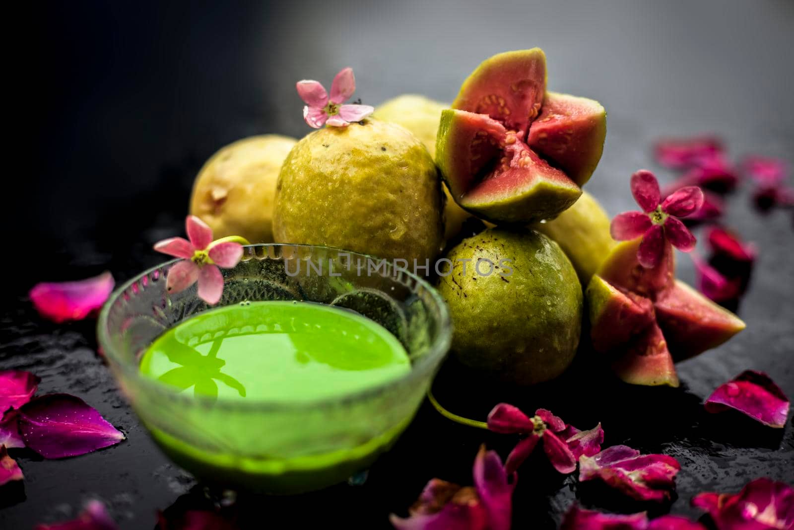 Guava, Neem or Indian lilac leaves, turmeric powder well mixed in a glass bowl for treatment of pimples and acne in the spa by beauticians. by mirzamlk