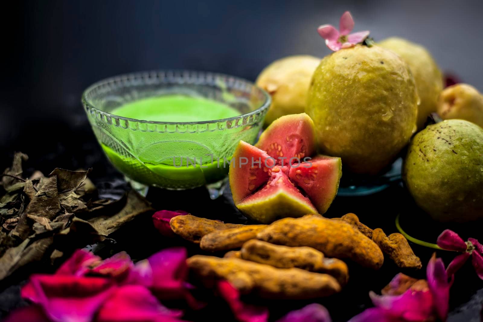 Guava, Neem or Indian lilac leaves, turmeric powder well mixed in a glass bowl for treatment of pimples and acne in the spa by beauticians.