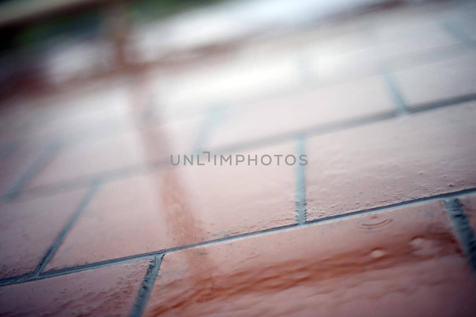 Close Up Abstract of Wet Brick Terracotta Tiles as part of Outdoor Patio Floor in Rainy Weather with Reflections