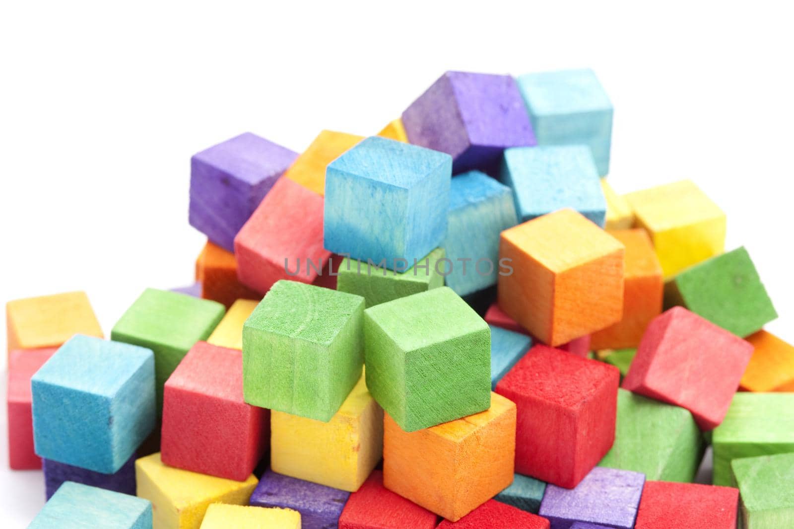 Jumbled Pile of Colorful Wooden Toy Blocks in Childhood Concept Image in Studio with White Background and Copy Space
