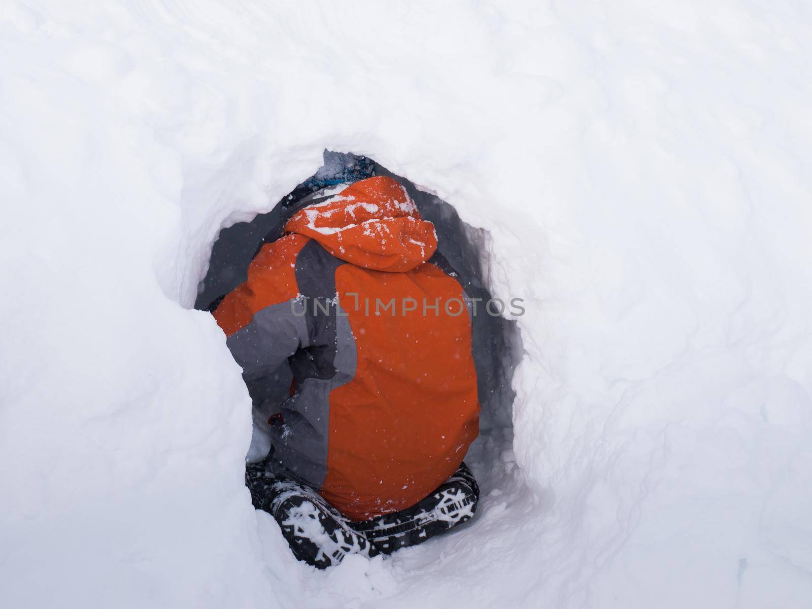 A boy digging the snow cave.