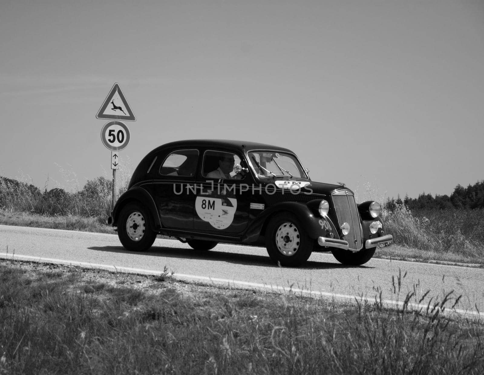 URBINO - ITALY - JUN 16 - 2022 : LANCIA ARDESIA 1952 on an old racing car in rally Mille Miglia 2022 the famous italian historical race (1927-1957