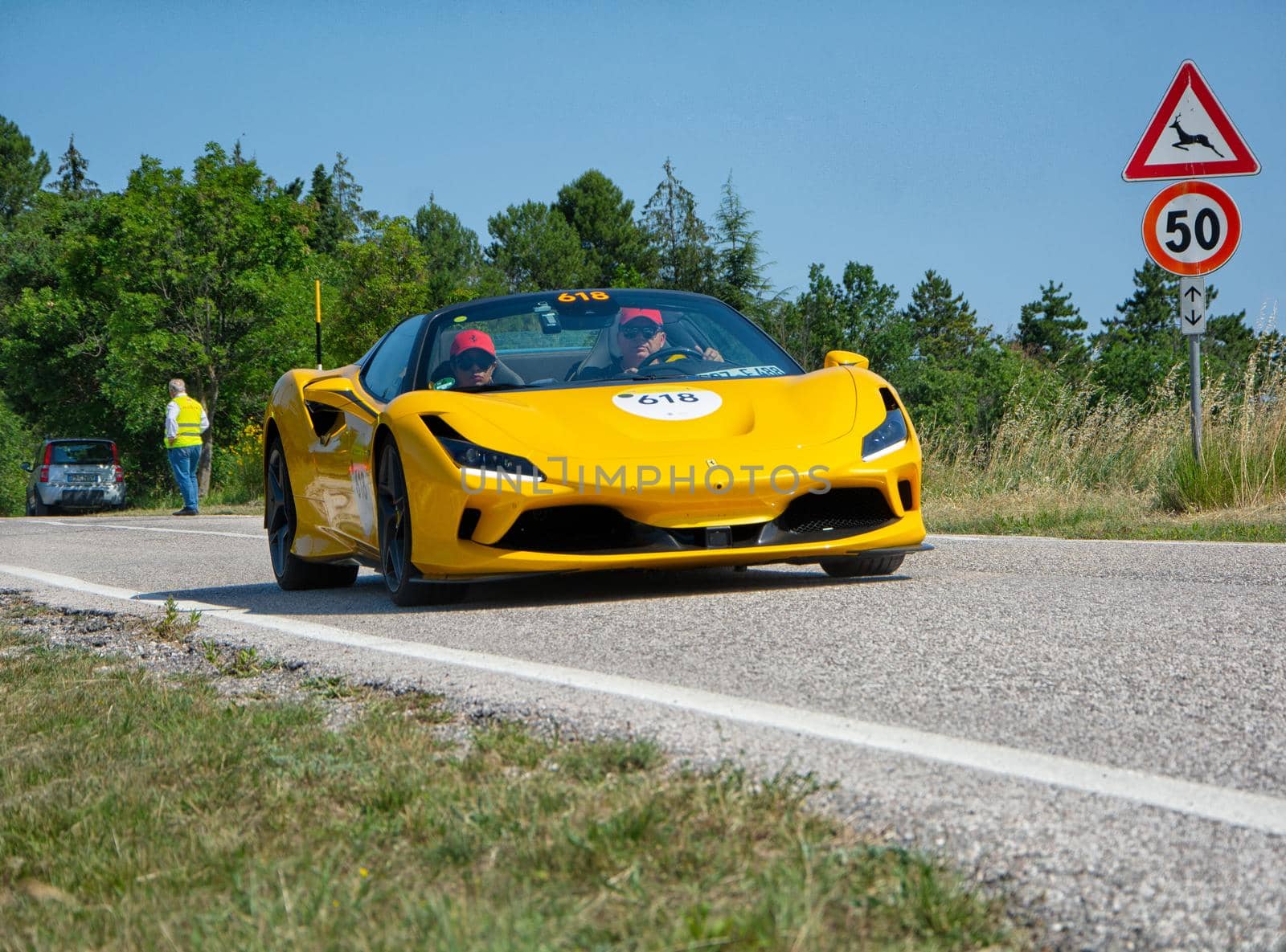 URBINO - ITALY - JUN 16 - 2022 : FERRARI F8 SPIDER 2022 on an old racing car in rally Mille Miglia 2022 the famous italian historical race (1927-1957