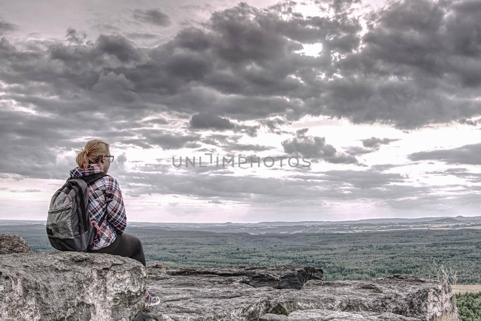 Blonde girl sits alone at edge  above the abyss  by rdonar2