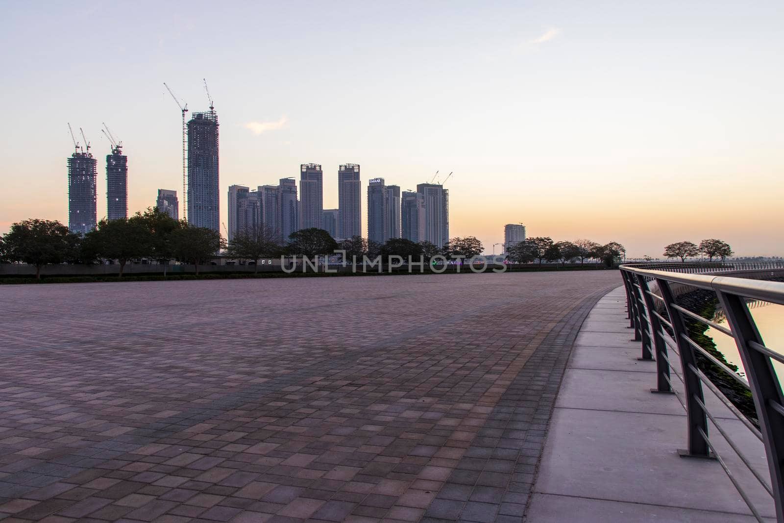 Dubai, UAE - 01.29.2021 Sunrise over Dubai city skyline. Creek Harbor by EMAAR. Outdoors by pazemin