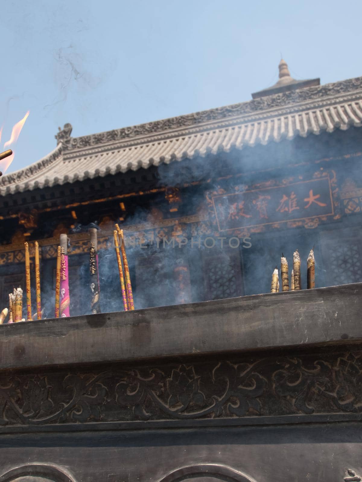 Candle burning at the buddhist temple in Xian, China.