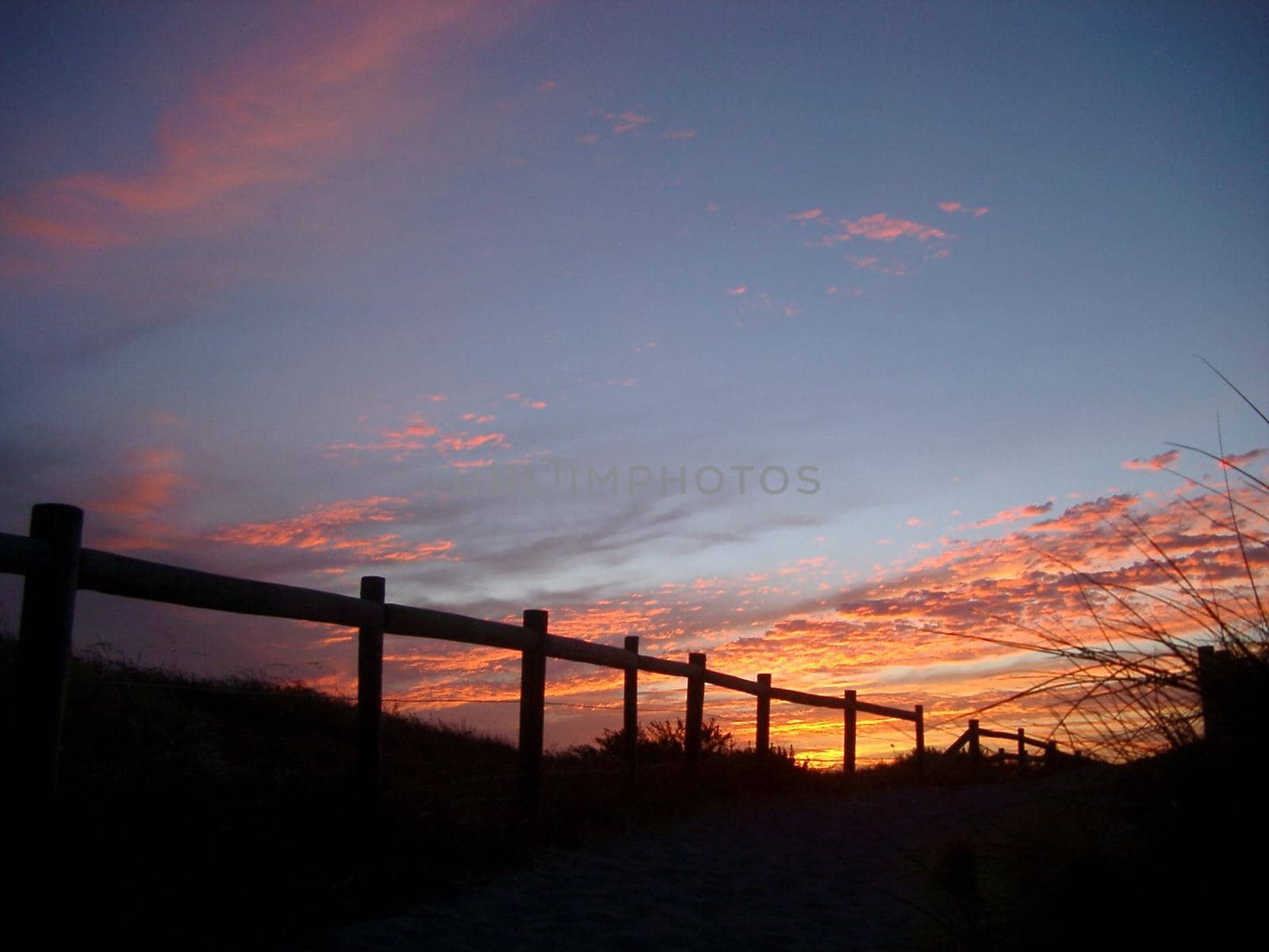 fence sunset silhouette, sand dunes near perth, WA.