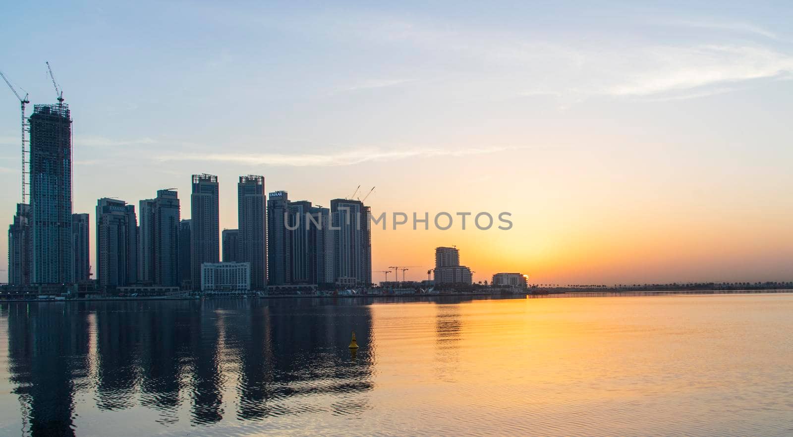 Dubai, UAE - 01.29.2021 Sunrise over Dubai city skyline. Creek Harbor by EMAAR. Outdoors by pazemin