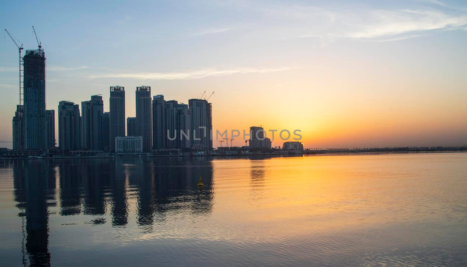 Dubai, UAE - 01.29.2021 Sunrise over Dubai city skyline. Creek Harbor by EMAAR. Outdoors by pazemin