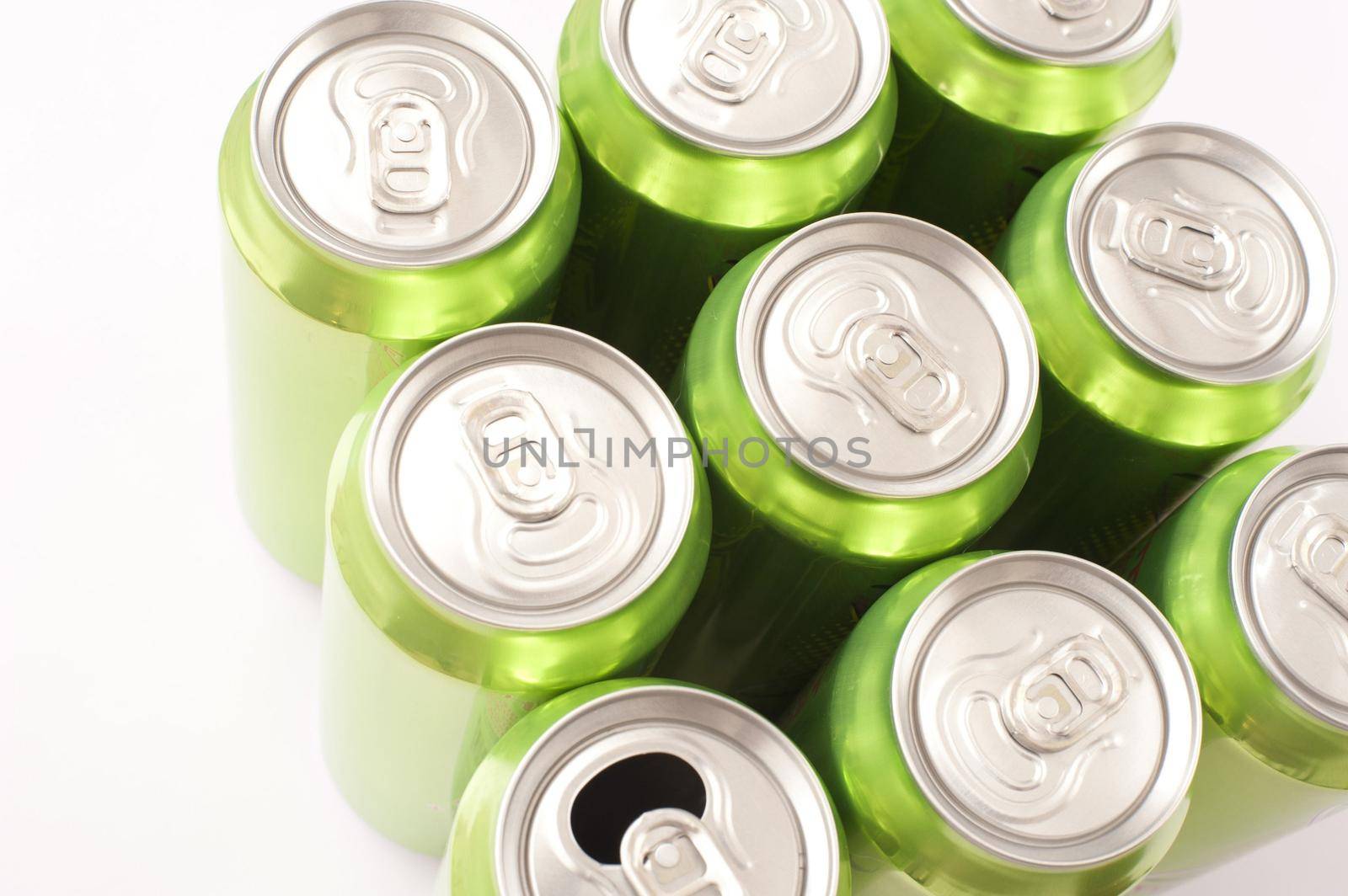 Nine grouped green cans of energy drink viewed from above with eight closed tabs and one that has been pulled and opened