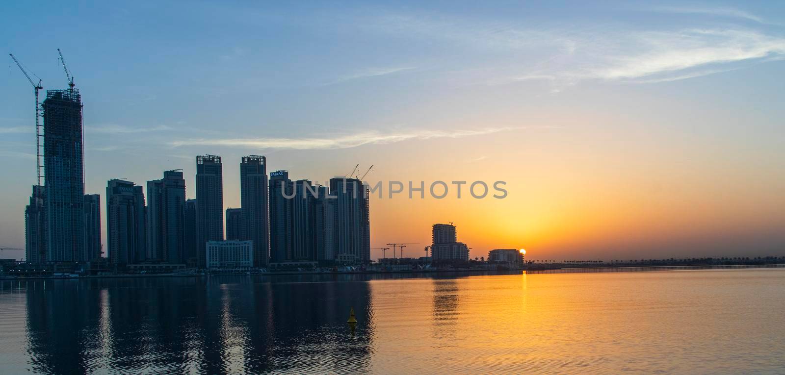 Dubai, UAE - 01.29.2021 Sunrise over Dubai city skyline. Creek Harbor by EMAAR. Outdoors by pazemin