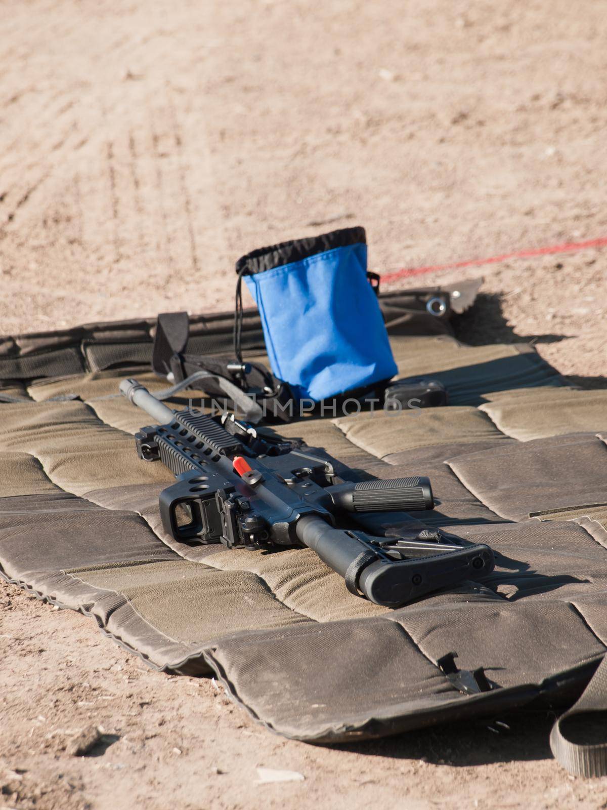 Rifle on the shooting mat with safety on.