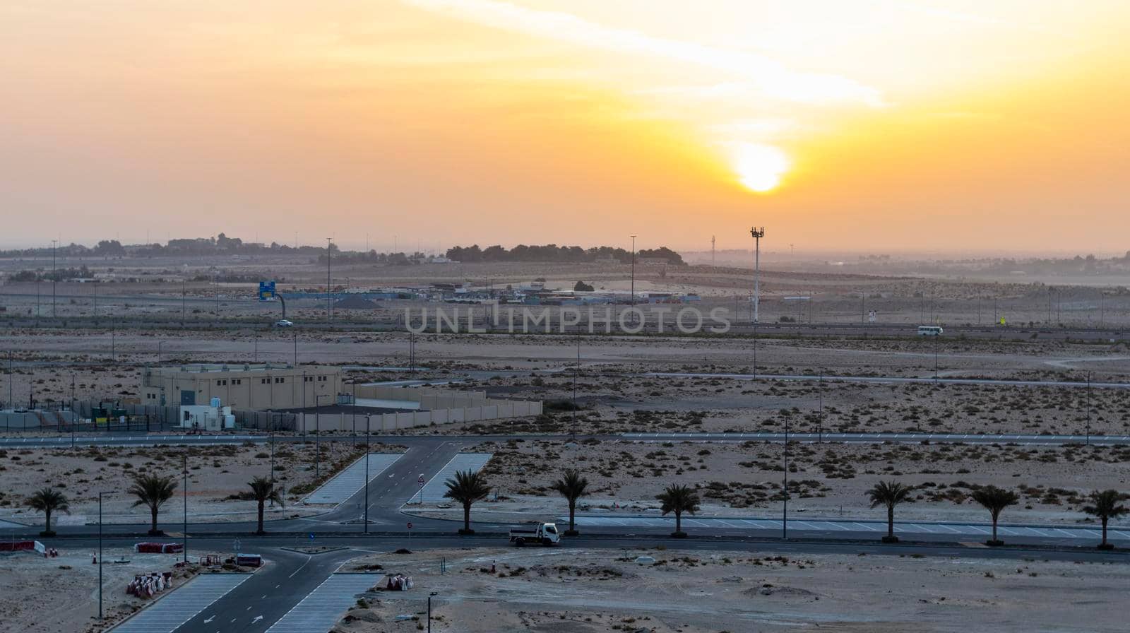 Shot of a sunrise over empty area of the city