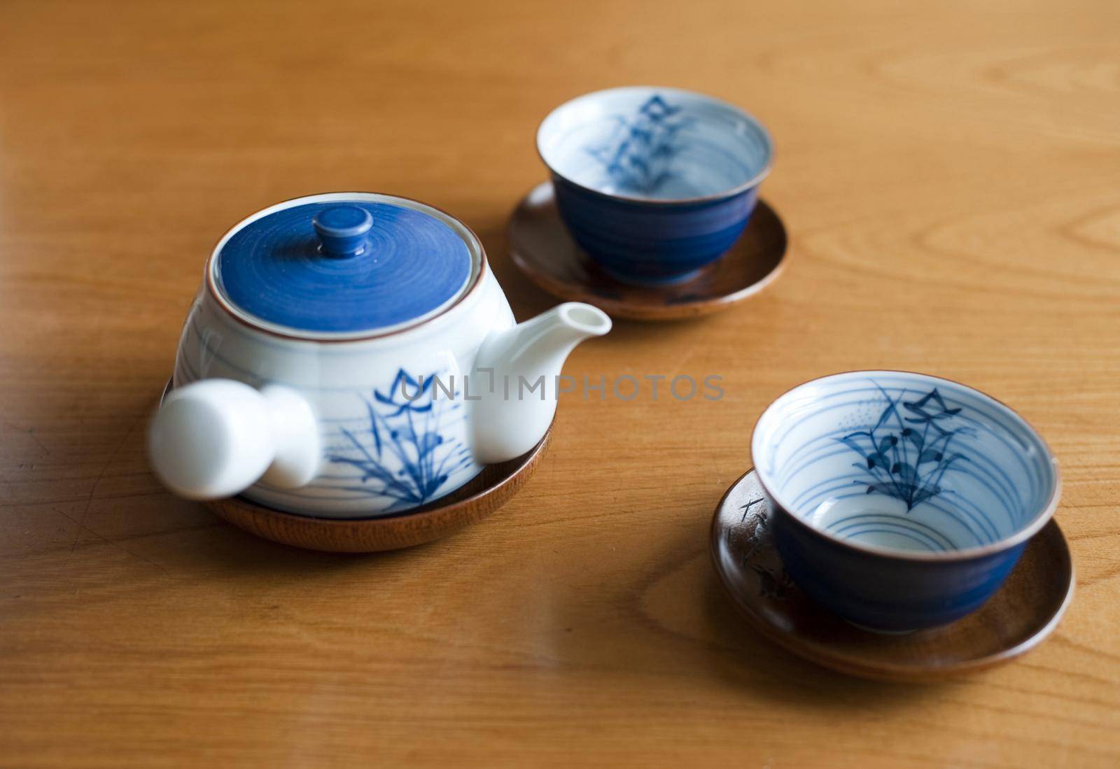 relaxing the body - tea cups and a teapot for a refreshing cup of green tea