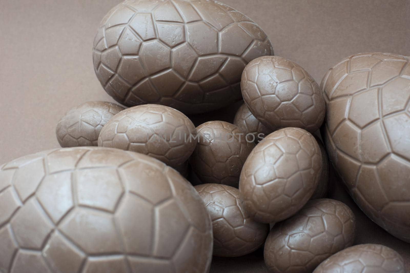 Chocolate treat of a collection of different sized unwrapped milk chocolate eggs