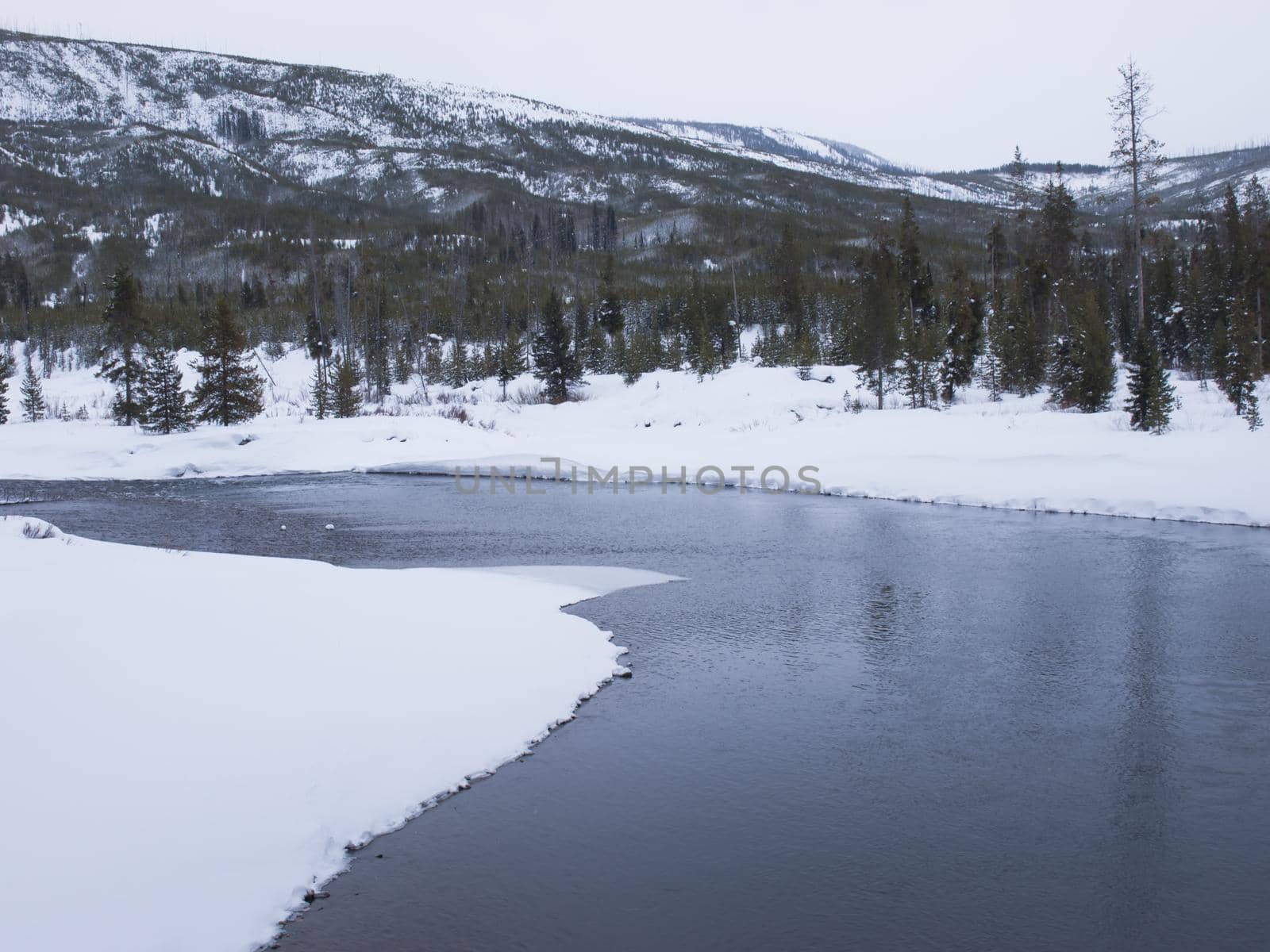 Winter landscape with frozen river in the Great Teton national park.