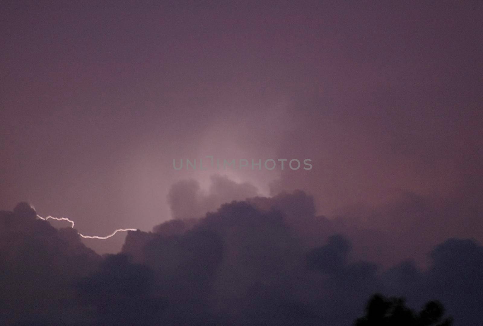 lighting flash between clouds in a thunderstorm - blurred image
