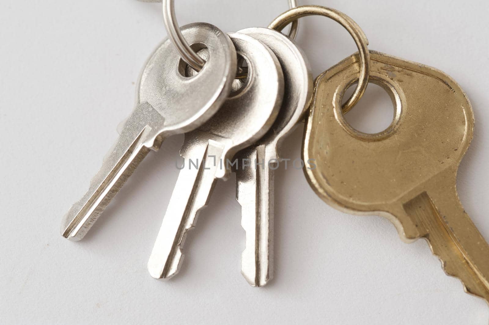 Security Concept - Close up Luggage Keys on a Ring , on Off White Background.