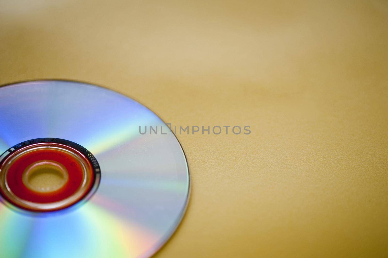 an audio compact disc on a yellow backdrop