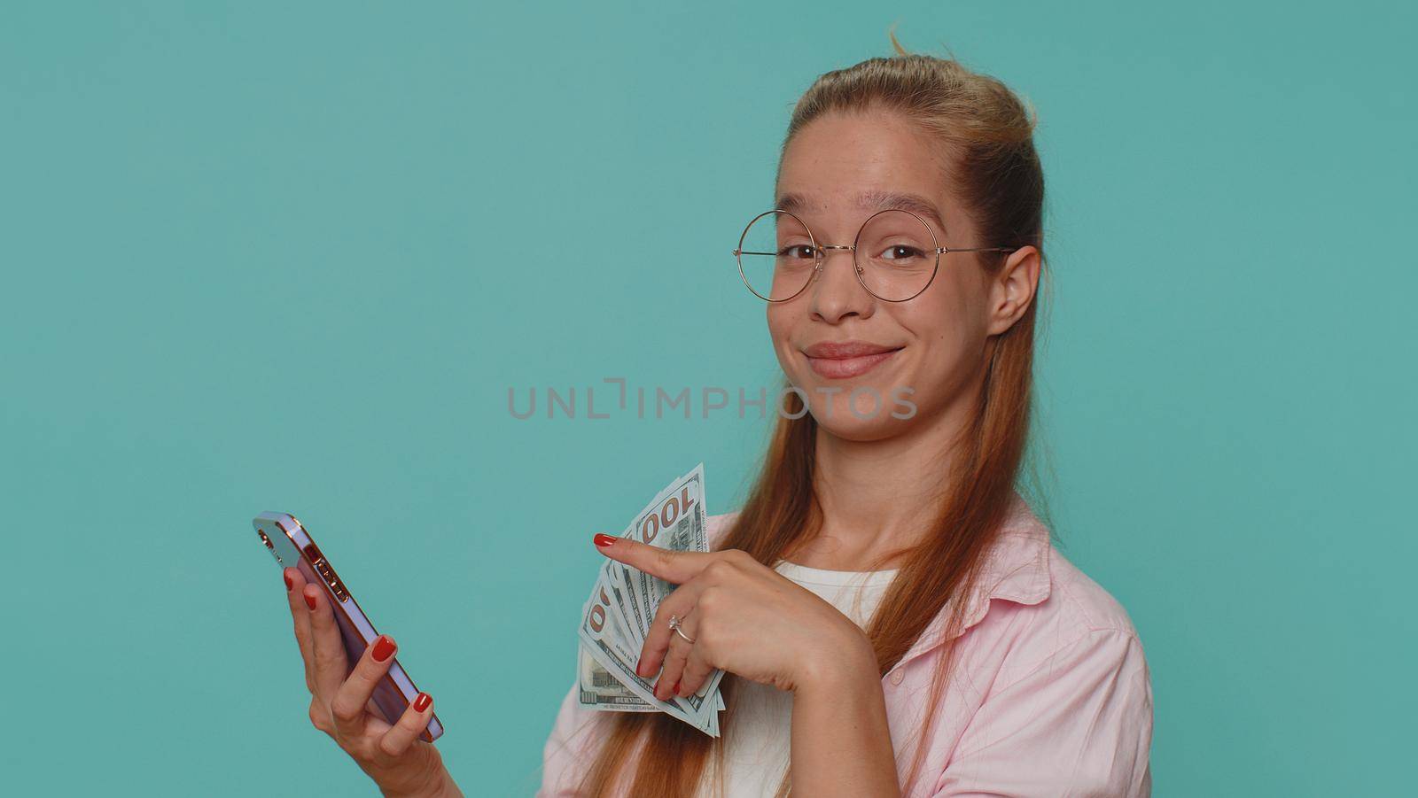 Pretty teen female child kid using smartphone typing new post on web, browsing, searching, addiction of social networks, show thumbs up like, positive feedback, recommends wifi cellular connection 5G