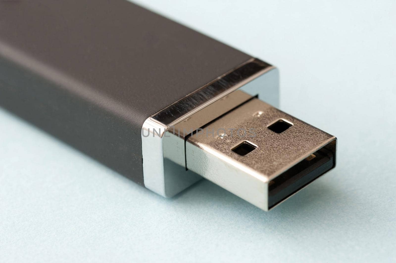 USB flash memory computer stick open to display the universal connector in a close up view on white