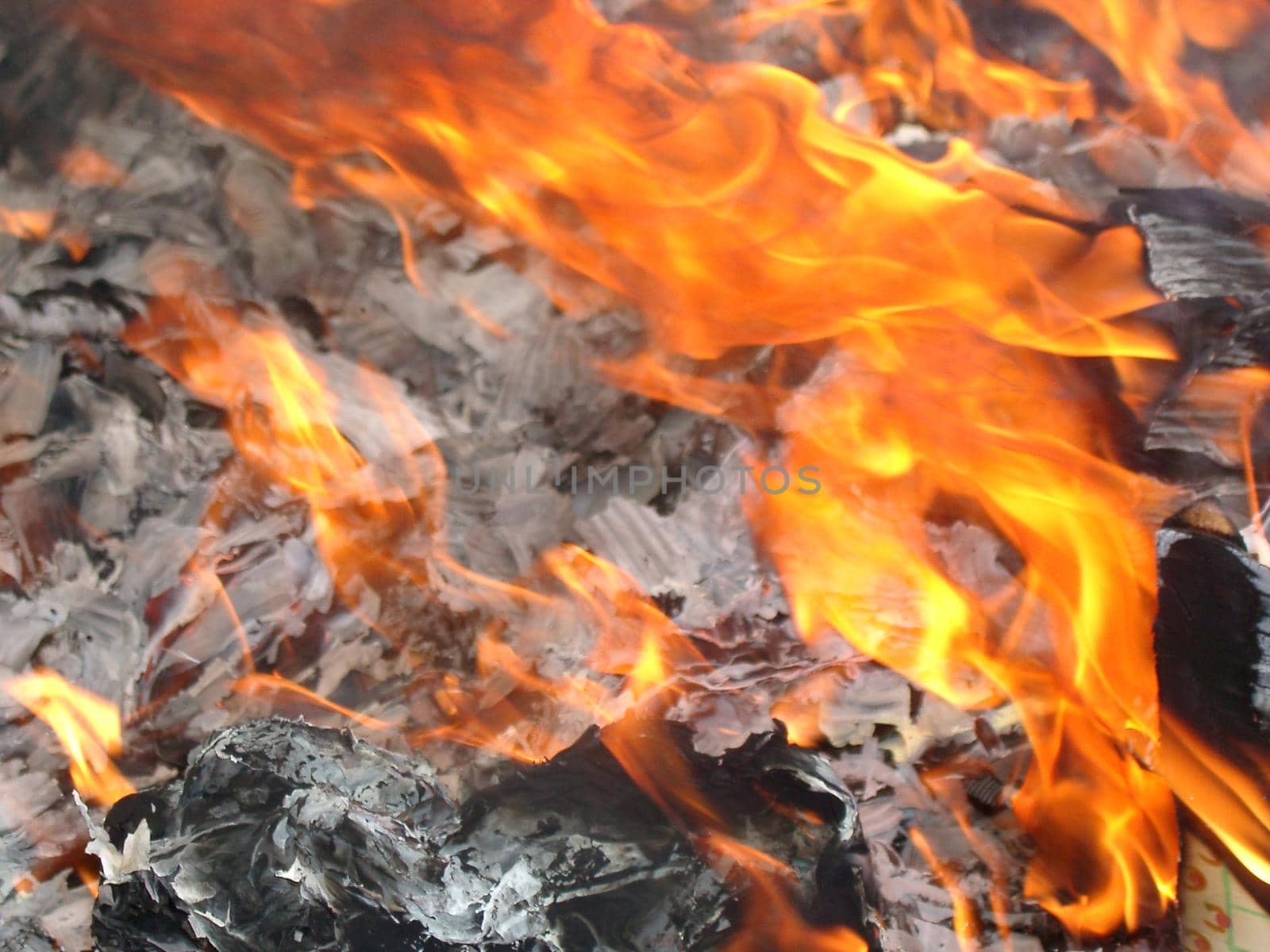 Orange flames licking across burning rubbish as a means of keeping the environment clean and free of waste pollution