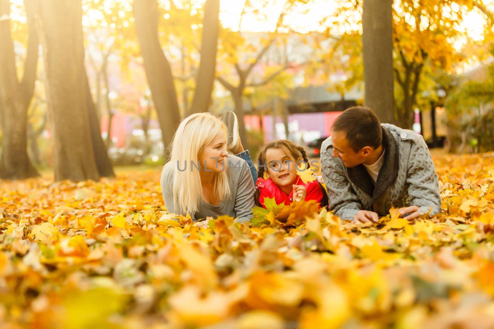 Happy beautiful family playing and laughing on autumn walk by Andelov13