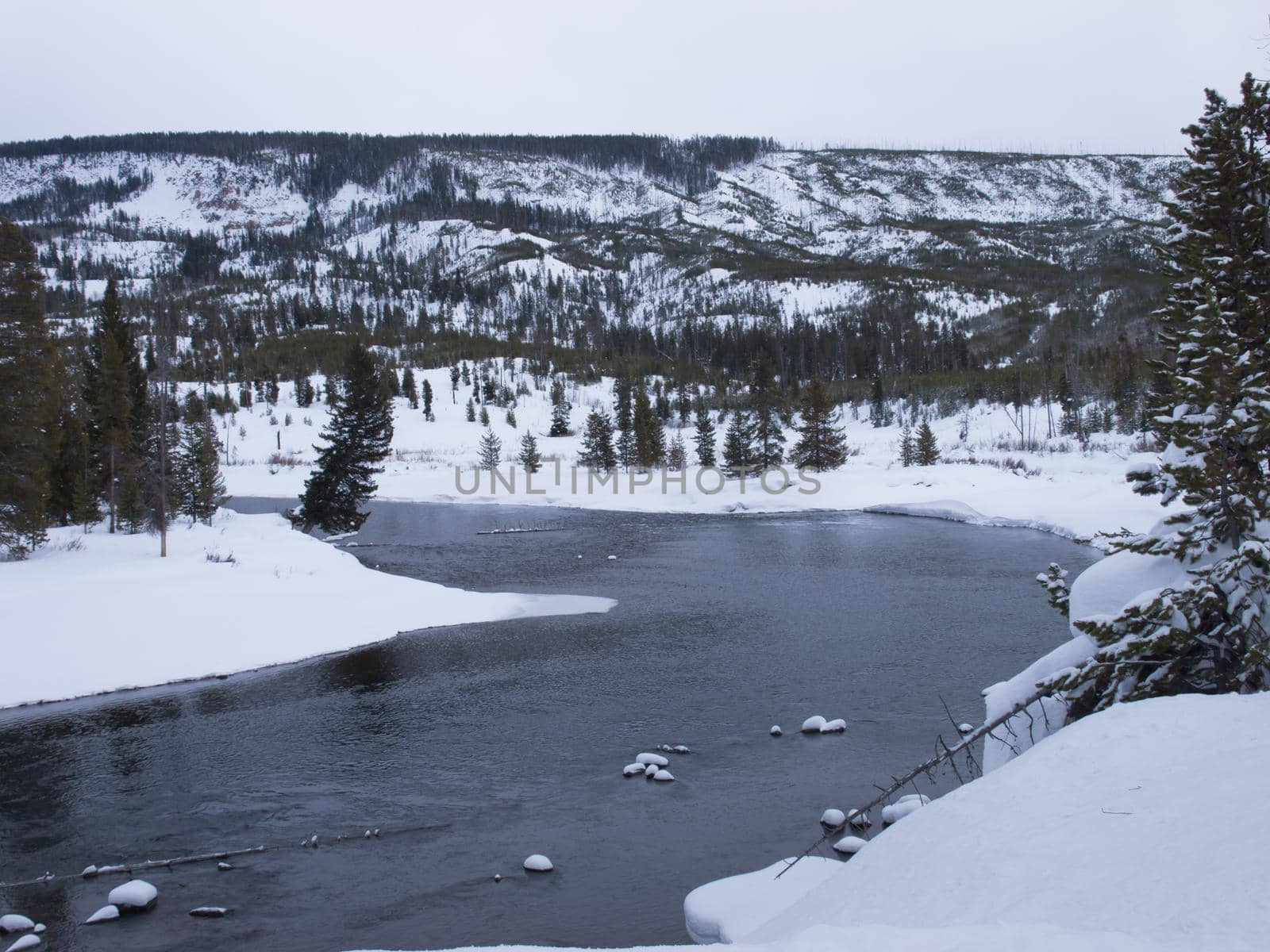 Winter landscape with frozen river in the Great Teton national park.