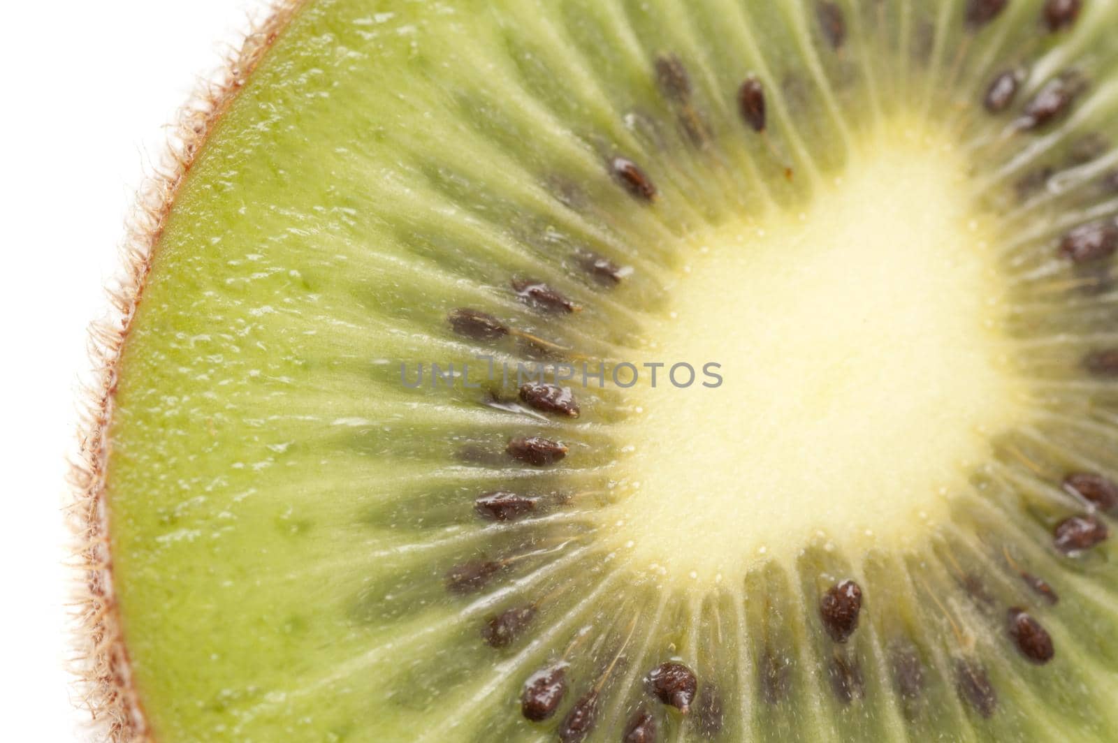 Close up texture of a fresh sliced kiwifruit showing the succulent sweet juicy flesh and pattern of pips