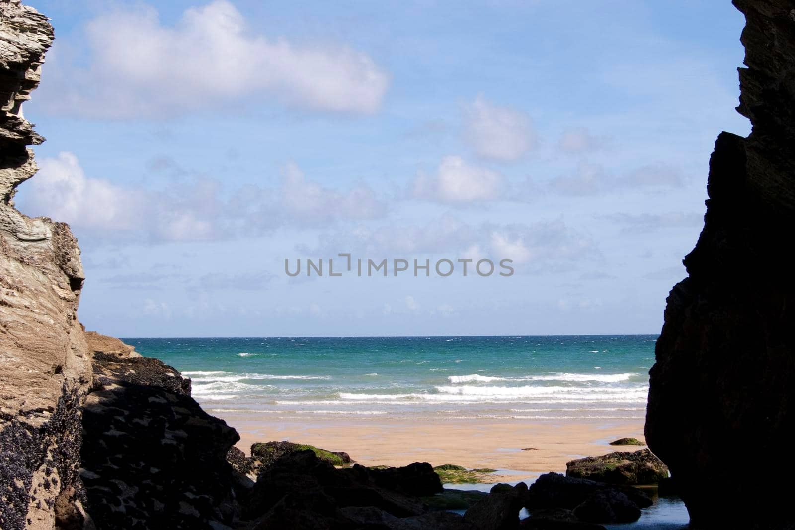 looking out to sea from a secluded cove on a beach near newquay