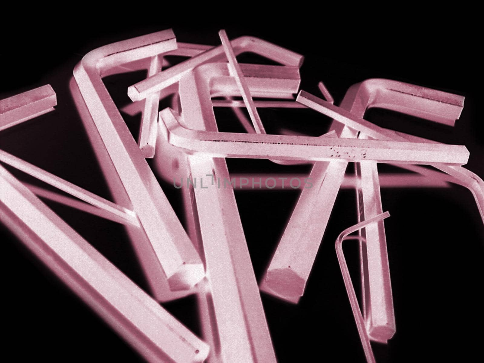 Reverse exposure red tinted set of various sized hex wrenches over black background