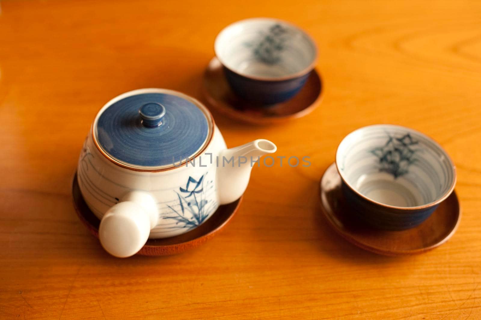 japanese teapot and cups in a wooden table