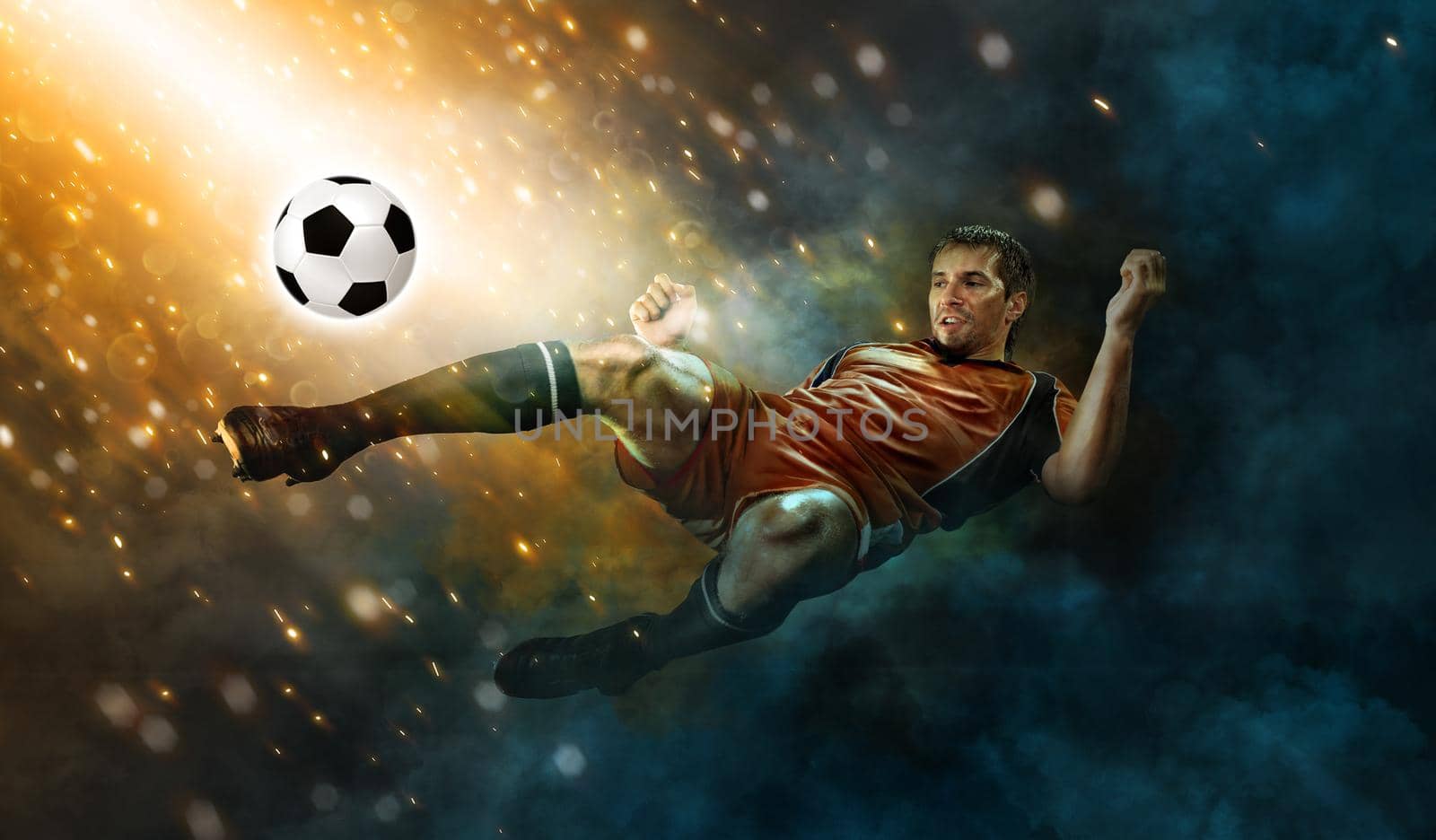 Football or soccer player in action on stadium with flashlights, kicking ball for winning goal. Concept of sport, competition, motion