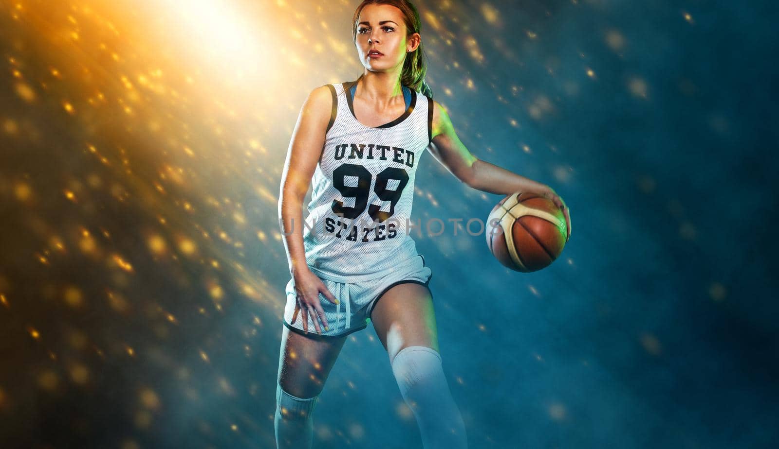 Basketball player. Portrait of a beautiful and sexy woman with a basketball in studio. Sport concept by MikeOrlov